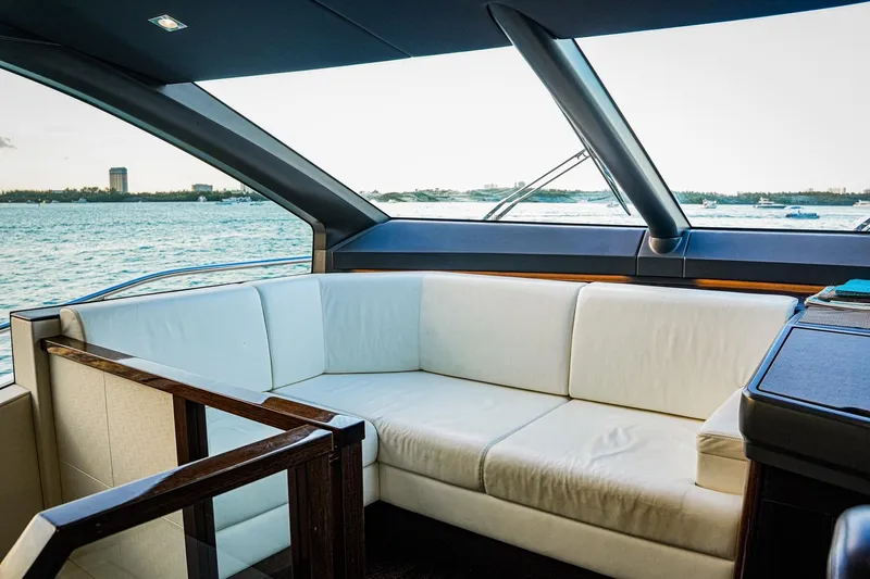 Solaire Yacht Photos Pics Luxurious interior of 2019 Sunseeker 76 Yacht with white seating and ocean view.