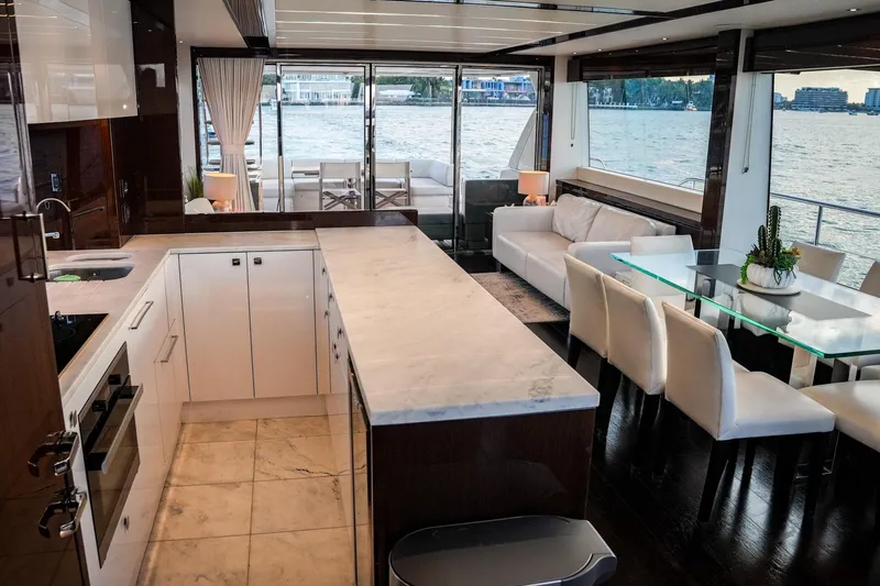 Solaire Yacht Photos Pics Luxurious interior of 2019 Sunseeker 76 Yacht with modern kitchen and elegant dining area.