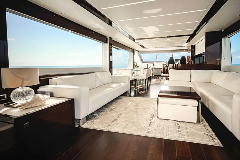Solaire Yacht Photos Pics Luxurious interior of 2019 Sunseeker 76 Yacht with elegant white seating and ocean view.