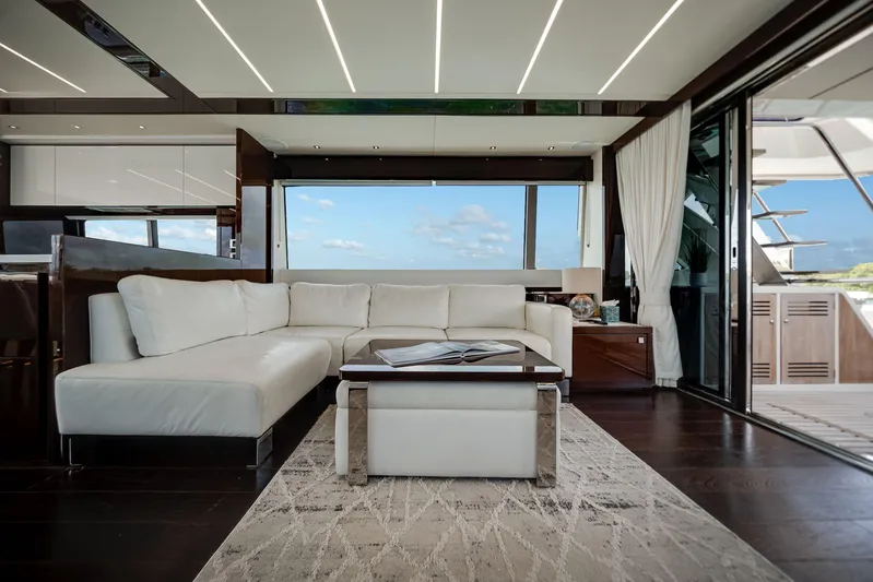 Solaire Yacht Photos Pics Luxurious interior of 2019 Sunseeker 76 Yacht with white leather seating and ocean view.