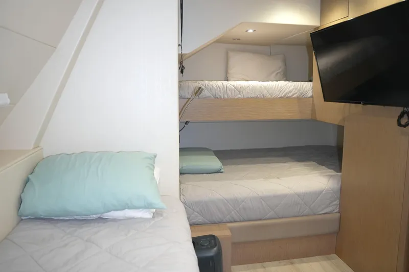 Solaire Yacht Photos Pics Interior of 2019 Sunseeker 76 Yacht cabin with bunk beds and TV.
