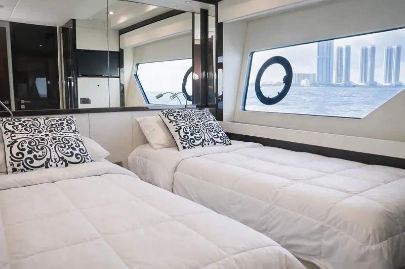 Solaire Yacht Photos Pics Luxurious twin bedroom on 2019 Sunseeker 76 Yacht with ocean view and elegant decor.