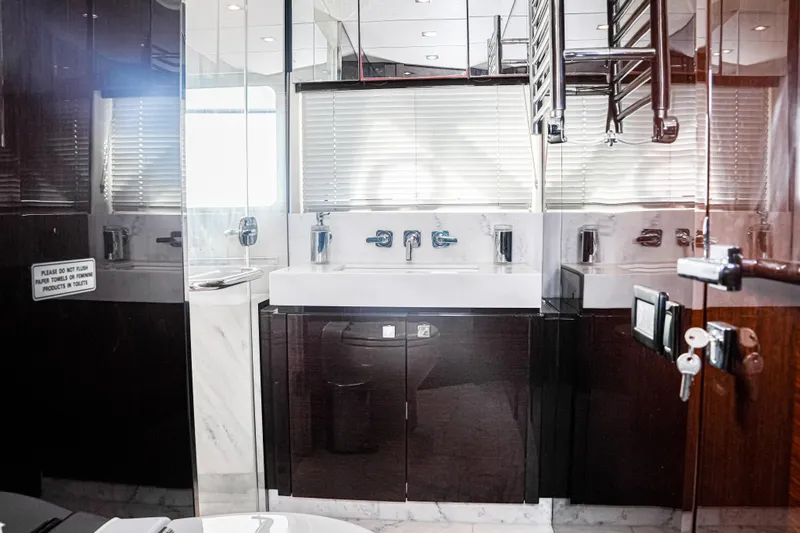 Solaire Yacht Photos Pics Luxurious bathroom interior of 2019 Sunseeker 76 Yacht with modern fixtures and elegant design.