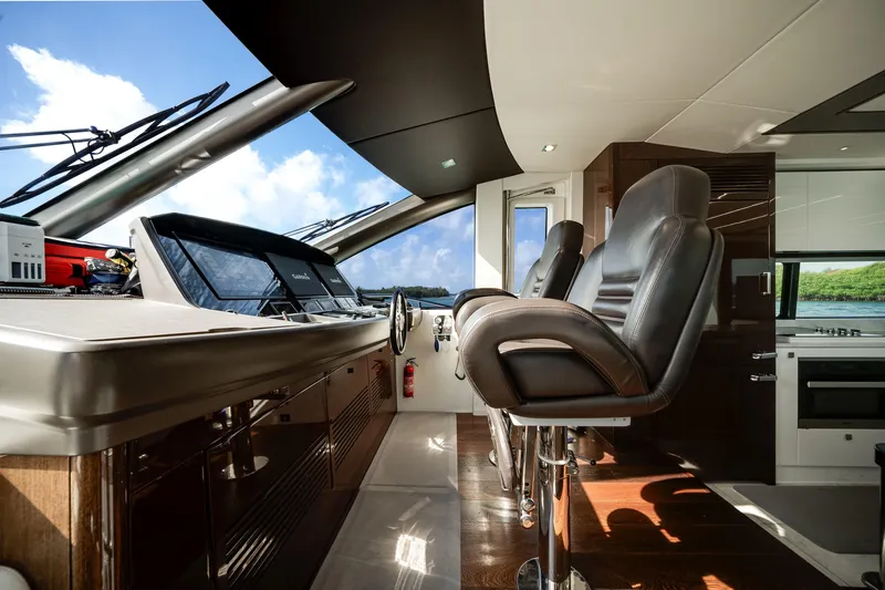 Solaire Yacht Photos Pics Luxurious interior of 2019 Sunseeker 76 Yacht with modern helm and leather seating.