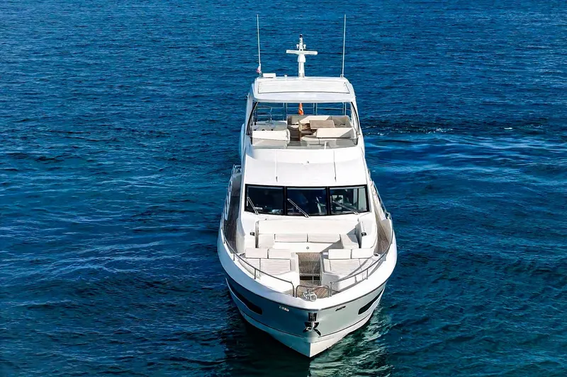 Solaire Yacht Photos Pics 2019 Sunseeker 76 Yacht on open blue sea, front view.