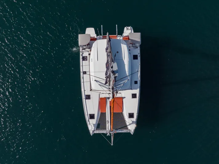 In Stock #169 Yacht Photos Pics Aerial view of 2024 Excess 11 catamaran on calm blue water.