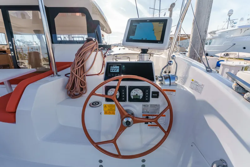 In Stock #169 Yacht Photos Pics 2024 Excess 11 yacht helm with navigation display and wooden steering wheel.