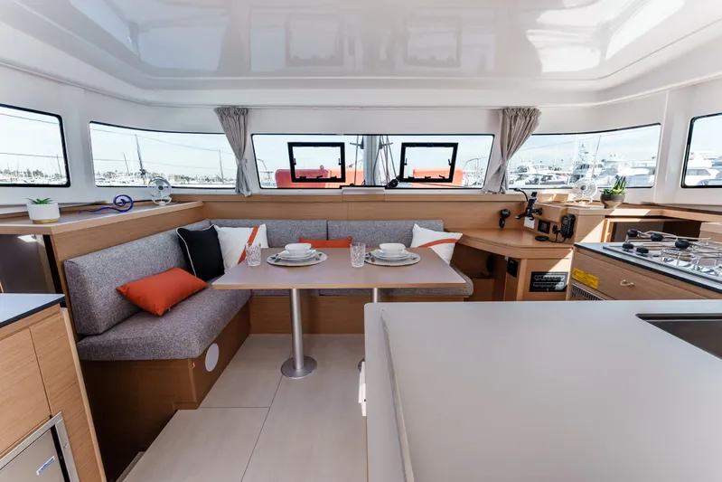 In Stock #169 Yacht Photos Pics Luxurious interior of 2024 Excess 11 yacht with modern dining area and kitchen.