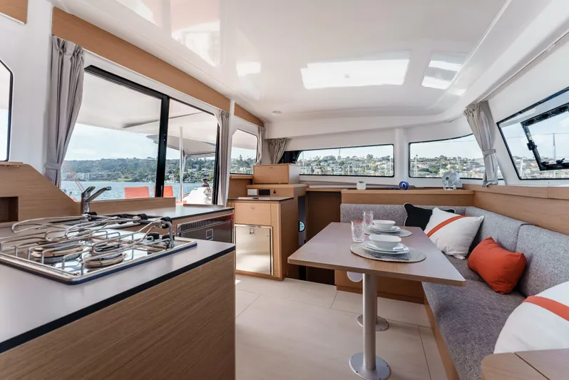 In Stock #169 Yacht Photos Pics Interior of 2024 Excess 11 catamaran with modern kitchen and dining area.