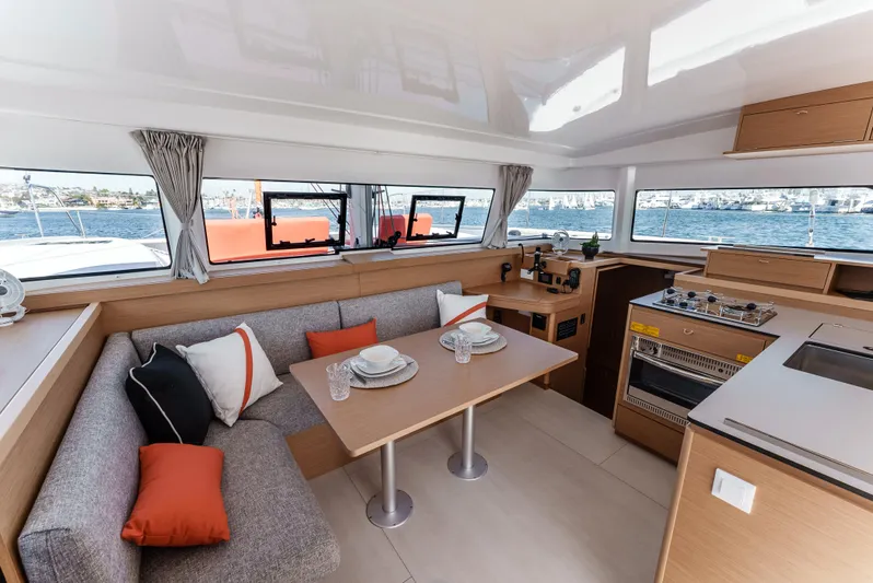 In Stock #169 Yacht Photos Pics Modern interior of 2024 Excess 11 yacht with dining area and kitchen.