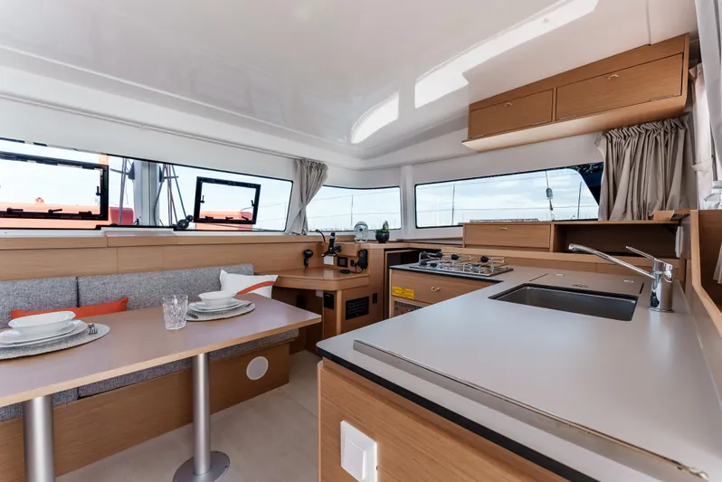 In Stock #169 Yacht Photos Pics Modern interior of 2024 Excess 11 yacht with kitchen and dining area.