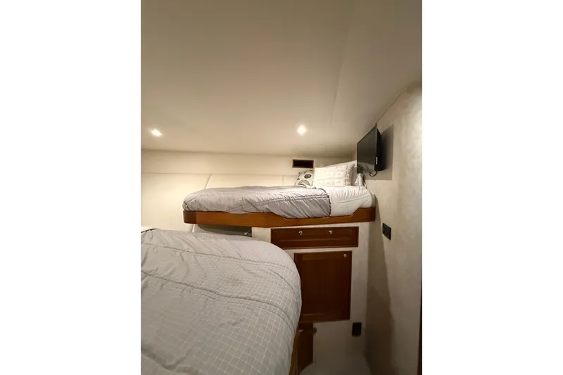  Yacht Photos Pics Interior of 2006 Blackwell 66 Convertible with cozy bunk beds and wall-mounted TV.