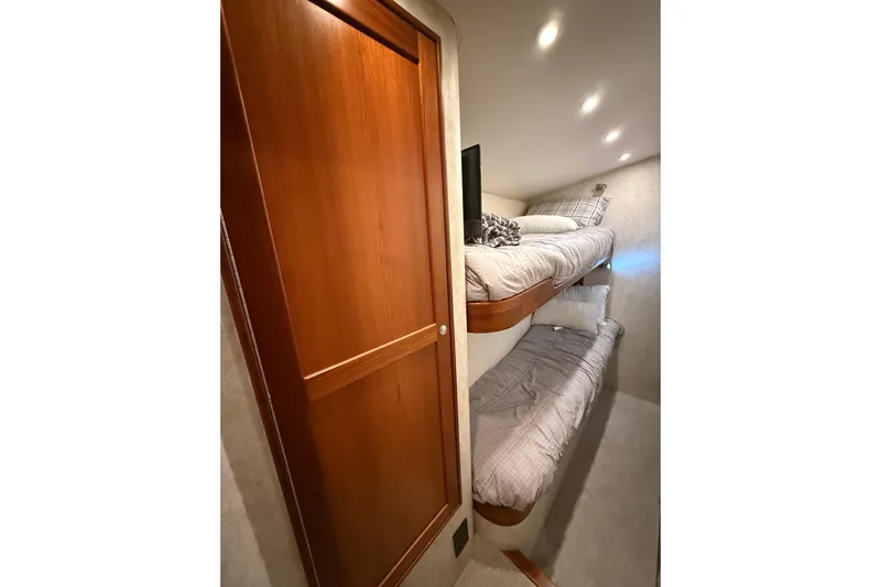  Yacht Photos Pics Interior of 2006 Blackwell 66 Convertible with cozy bunk beds and wooden door.