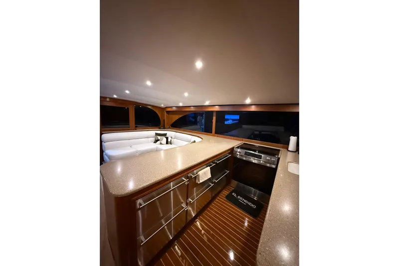  Yacht Photos Pics Luxurious interior of 2006 Blackwell 66 Convertible yacht with modern kitchen and seating area.