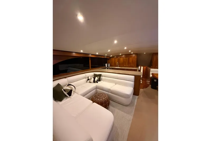  Yacht Photos Pics Luxurious interior of 2006 Blackwell 66 Convertible yacht with white seating and wooden accents.