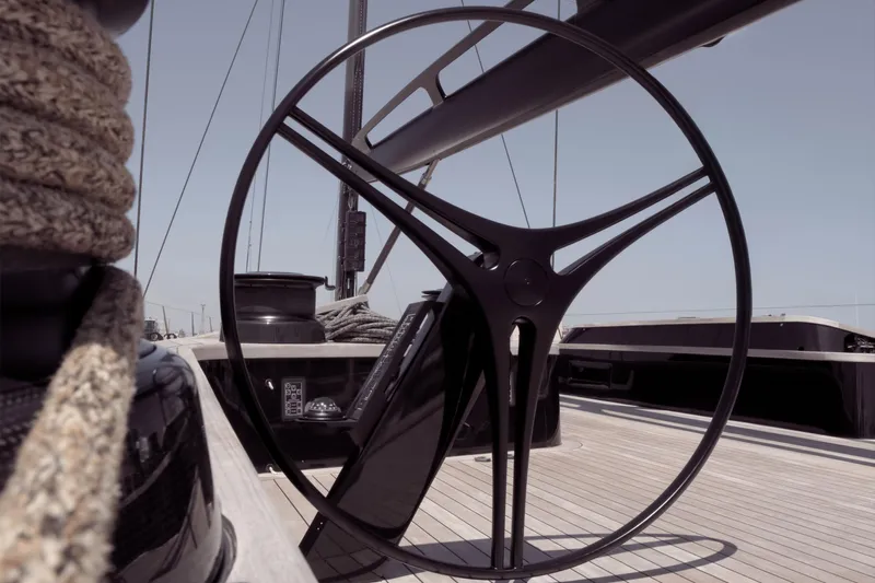 Bullitt Yacht Photos Pics Steering wheel of 2018 Wally Custom yacht on deck, featuring sleek design and nautical ropes.