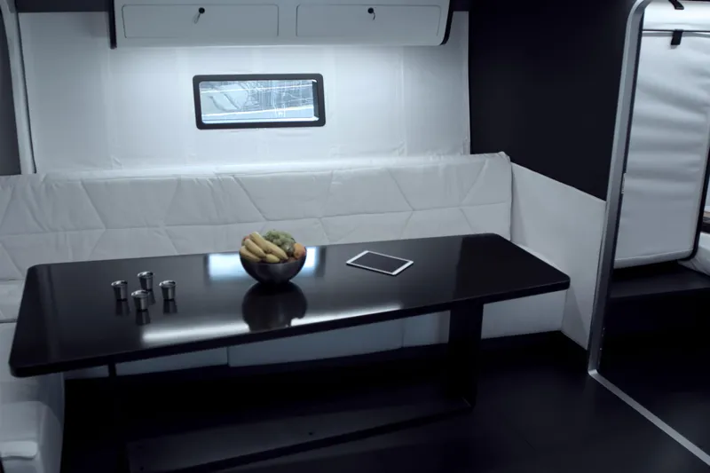 Bullitt Yacht Photos Pics Modern yacht interior with sleek black table, fruit bowl, and tablet, Wally Custom 2018.