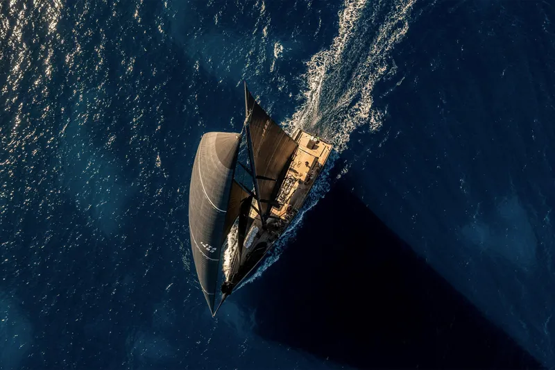 Bullitt Yacht Photos Pics Aerial view of 2018 Wally Custom sailboat navigating deep blue ocean waters.