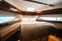 Luxurious cabin interior of 2020 Fairline Targa 45 Open yacht with elegant wood finishes.