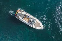 Aerial view of 2020 Fairline Targa 45 Open yacht cruising on clear blue water.