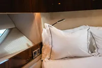 Luxurious cabin interior of 2020 Fairline Targa 45 Open yacht with elegant bedding.