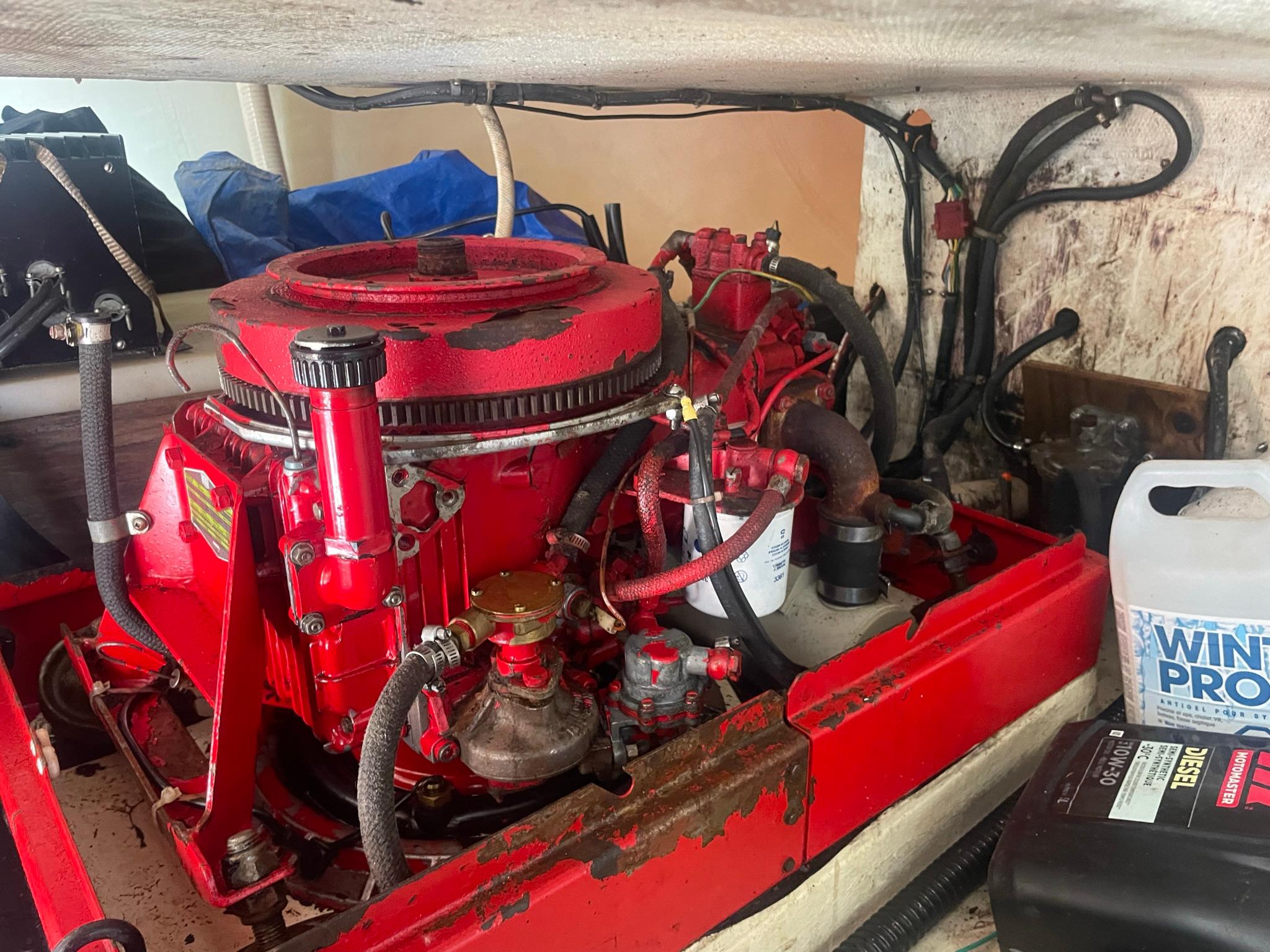 Red Reliance 12m engine from 1986 in a boat compartment.
