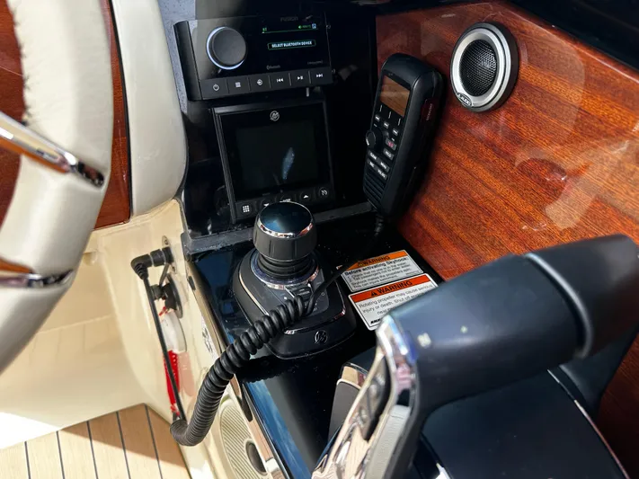  Yacht Photos Pics 2023 Chris-Craft Launch 31 GT dashboard with controls and wood paneling.
