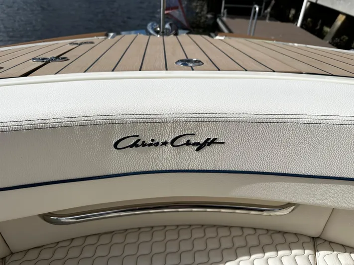  Yacht Photos Pics 2023 Chris-Craft Launch 31 GT boat interior with logo and wooden deck.