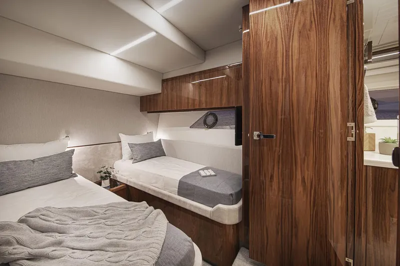  Yacht Photos Pics Manufacturer Provided Image: Luxurious cabin interior of 2021 Riviera 64 Sports Motor Yacht with twin beds.