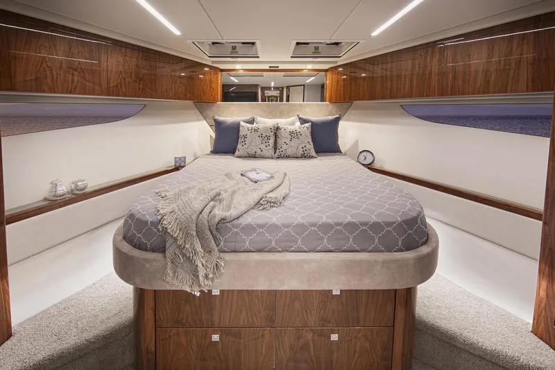  Yacht Photos Pics Manufacturer Provided Image: Luxurious bedroom interior of 2021 Riviera 64 Sports Motor Yacht with elegant wood finishes.