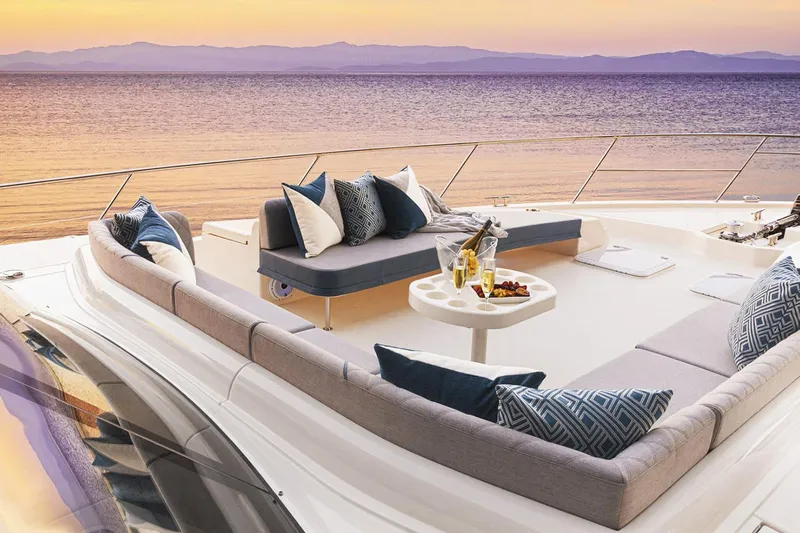  Yacht Photos Pics Manufacturer Provided Image: Luxurious 2021 Riviera 64 Sports Motor Yacht deck with sunset view and elegant seating.