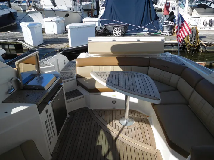  Yacht Photos Pics 2015 Sea Ray 350 SLX boat interior with seating and table at marina.