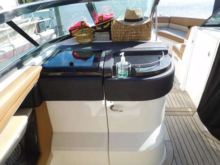  Yacht Photos Pics 2015 Sea Ray 350 SLX boat interior with hats and sanitizer on counter.