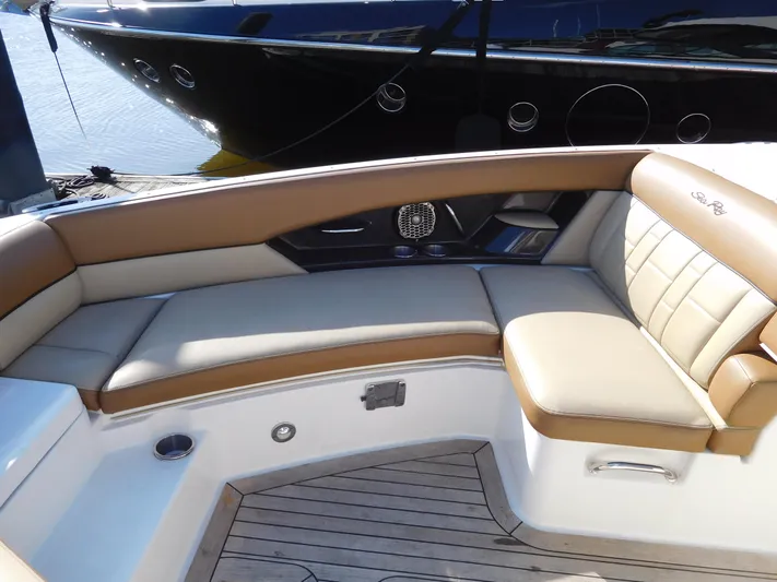  Yacht Photos Pics 2015 Sea Ray 350 SLX boat interior with tan leather seating and wood flooring.