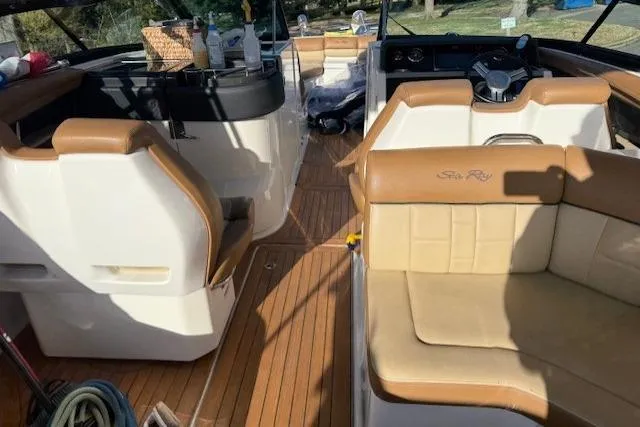  Yacht Photos Pics Interior of a 2015 Sea Ray 350 SLX boat with tan seating and wood flooring.