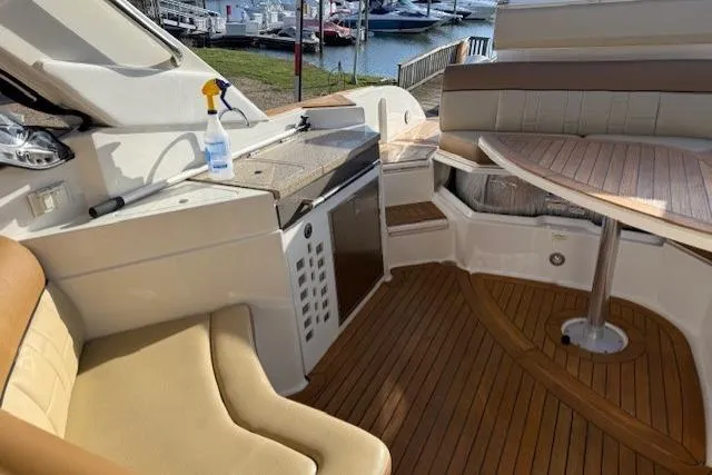  Yacht Photos Pics 2015 Sea Ray 350 SLX boat interior with seating, table, and kitchenette.
