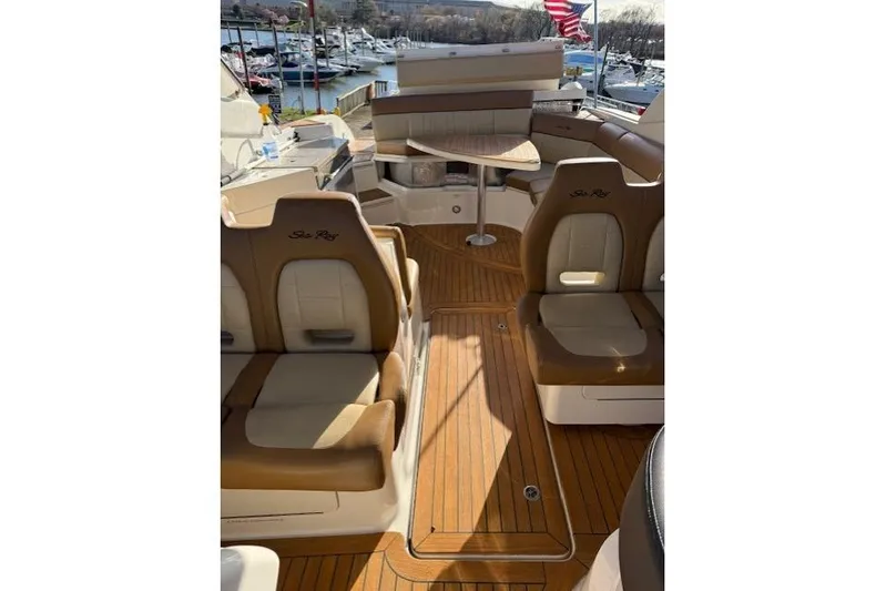  Yacht Photos Pics Interior of a 2015 Sea Ray 350 SLX boat with tan seating and wooden flooring.