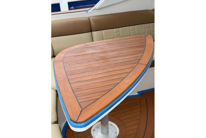  Yacht Photos Pics Teak table on 2015 Sea Ray 350 SLX boat with cushioned seating.