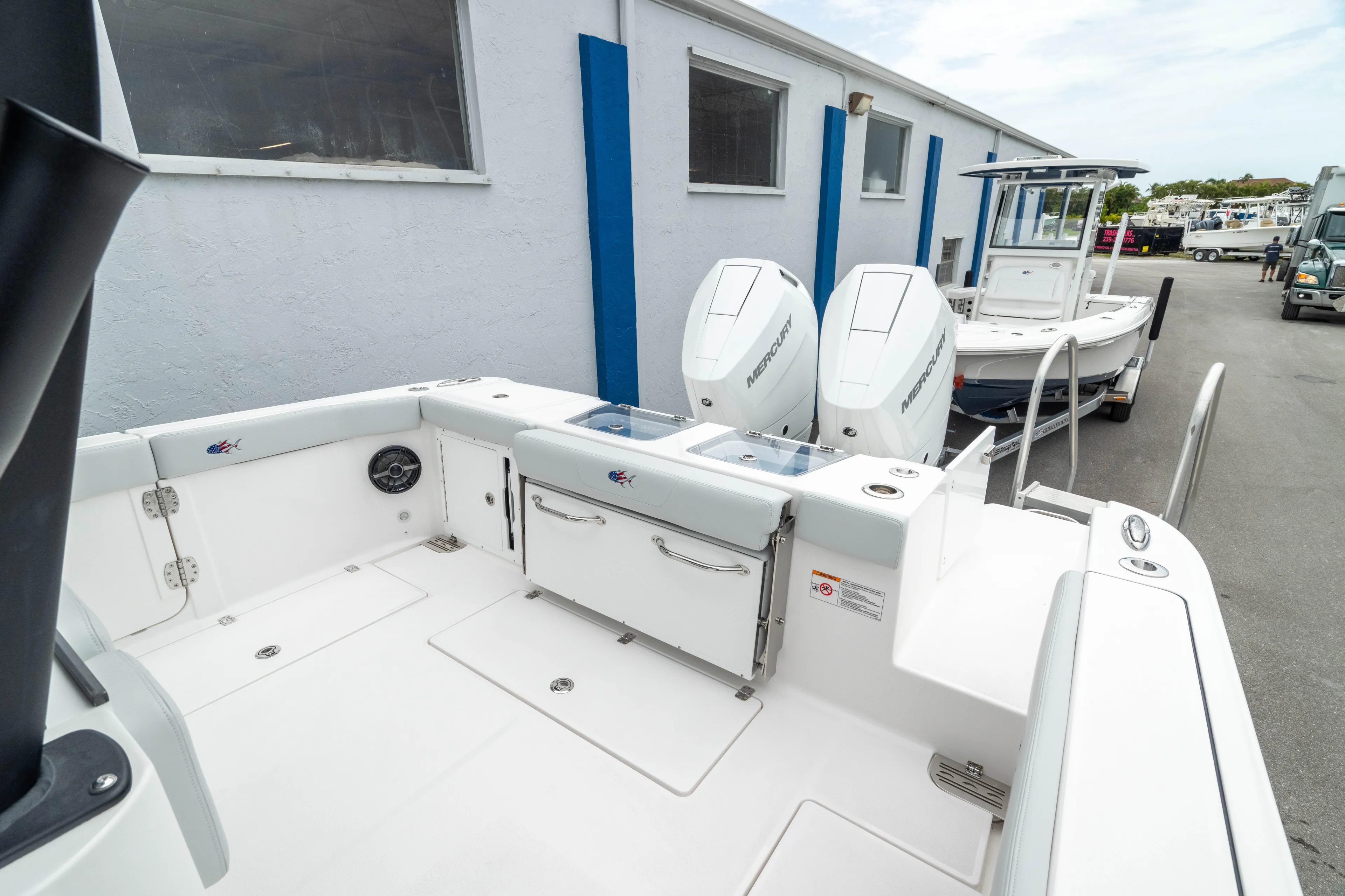  Yacht Photos Pics 2026 Crevalle 33 CSF boat with dual engines, docked near a building.