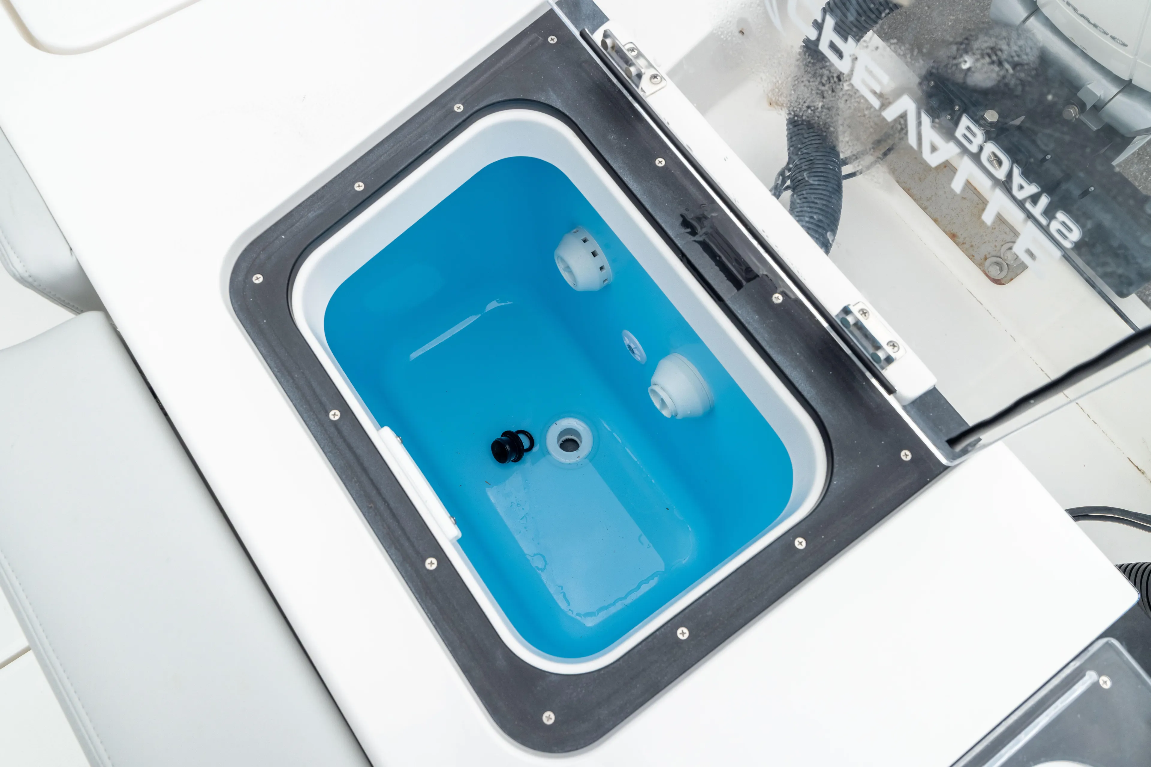  Yacht Photos Pics Livewell compartment on 2026 Crevalle 33 CSF boat, featuring a blue interior.