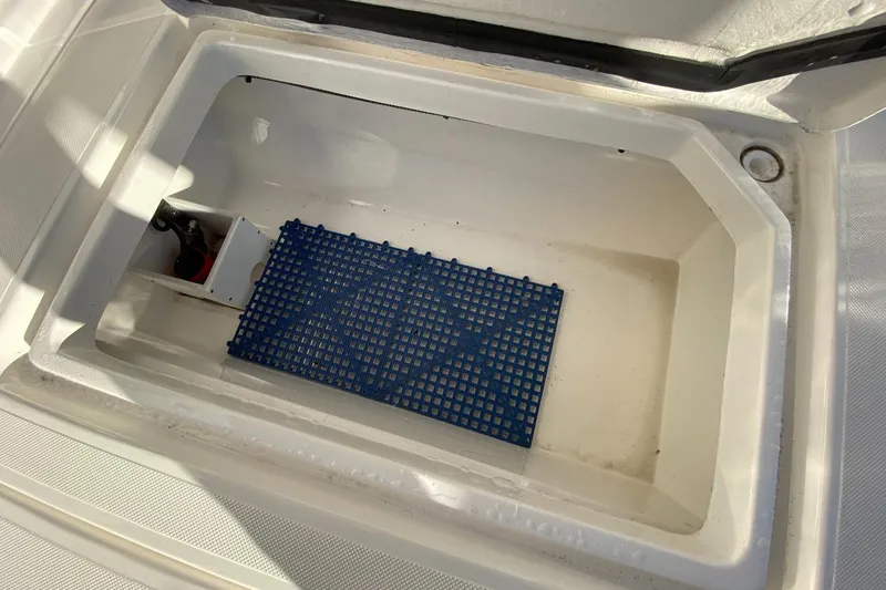  Yacht Photos Pics Open storage compartment in 2019 Aspen C107 boat with blue mat inside.