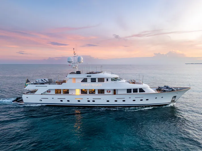 Sweet Escape Yacht Photos Pics Christensen 1993 Semi Displacement yacht cruising at sunset on the ocean.