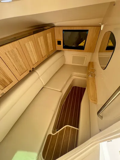  Yacht Photos Pics 2025 Grady-White 345 cabin interior with wood accents and comfortable seating.