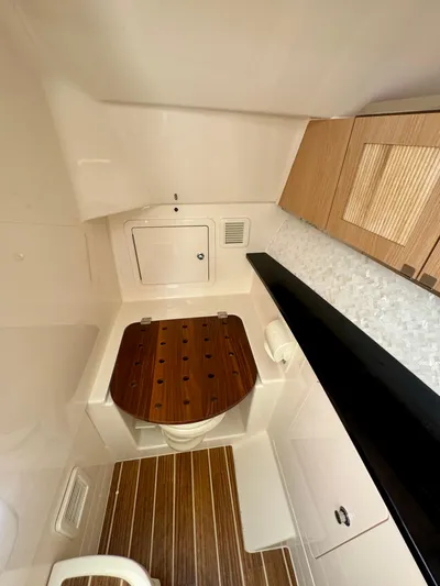  Yacht Photos Pics 2025 Grady-White 345 boat interior with modern wood and white finishes.