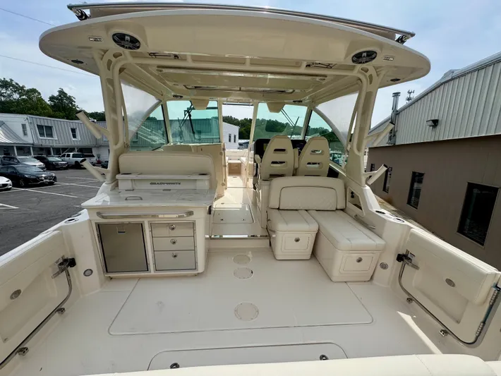  Yacht Photos Pics 2025 Grady-White 345 boat interior with seating and storage, docked outdoors.
