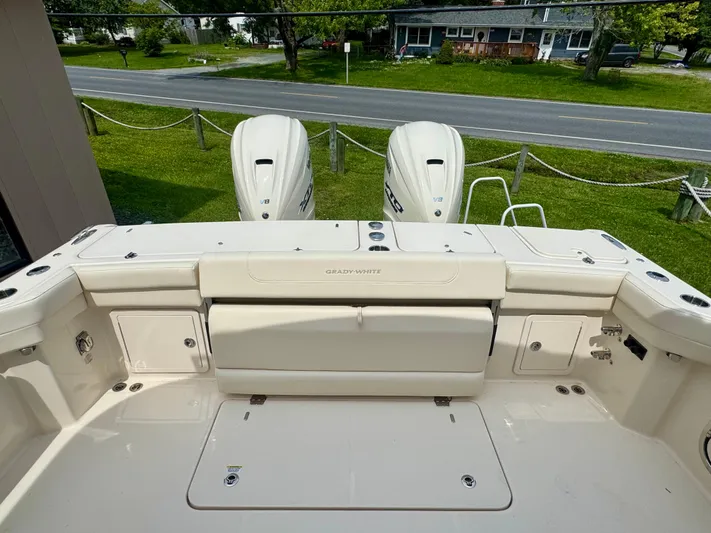  Yacht Photos Pics 2025 Grady-White 345 boat deck with dual outboard motors, parked near a road.