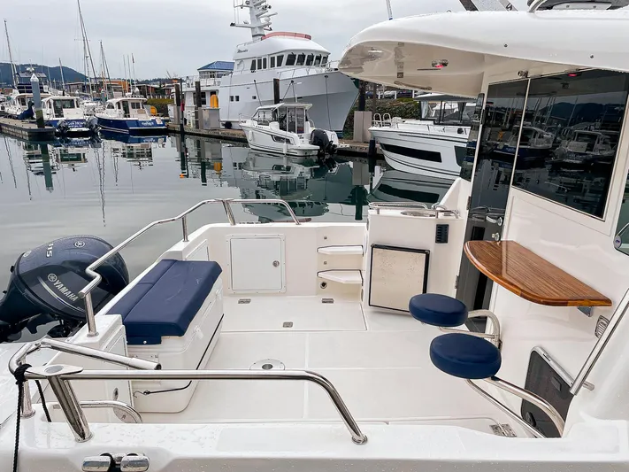 Sojourn Yacht Photos Pics Aspen C108 2022 boat docked at marina, featuring spacious deck and seating area.