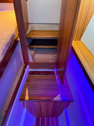 Sojourn Yacht Photos Pics 2022 Aspen C108 interior with wooden cabinetry and blue LED lighting.