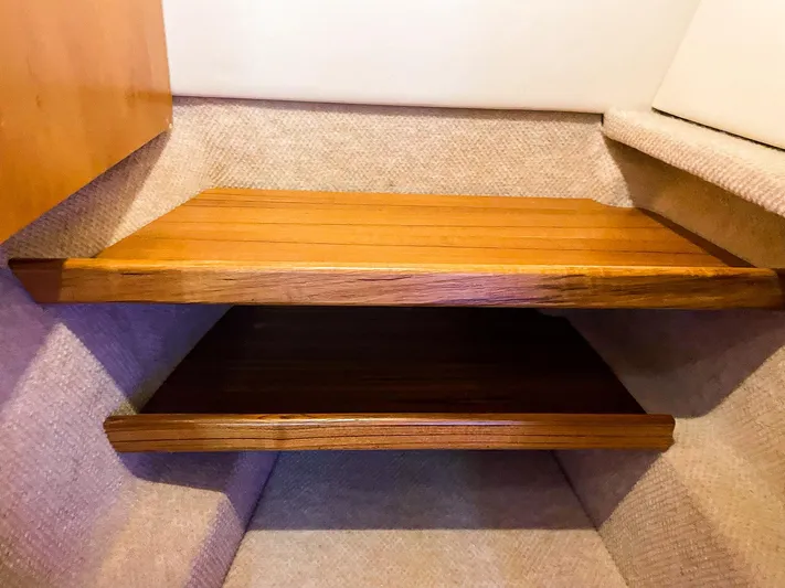 Sojourn Yacht Photos Pics Wooden steps inside a 2022 Aspen C108 boat, featuring a sleek, modern design.