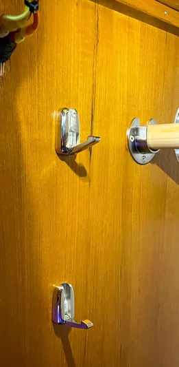 Sojourn Yacht Photos Pics Wooden door with metal hooks and a handle, Aspen C108, 2022 model.